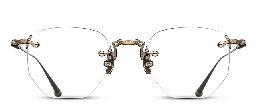 Pair of rimless glasses with an ornate gold frame on a white background