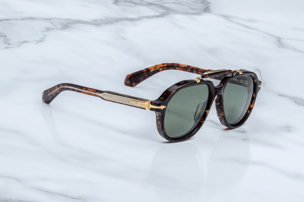 Side view brown tortoiseshell sunglasses with ornate gold hardware and green lenses