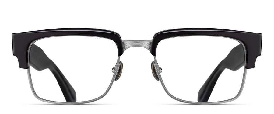 Eyeglasses with a black frame and antique silver hardware on a white background