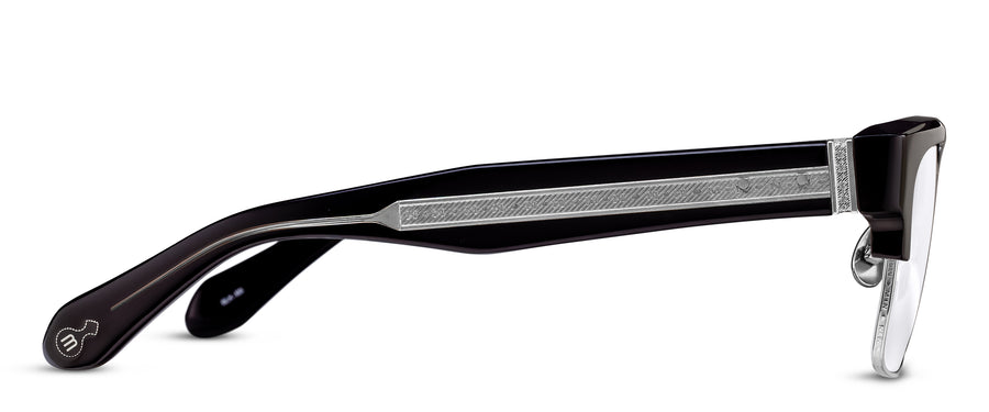 Eyeglasses with thick dark tortoiseshell temples and exposed silver hardware on a white background