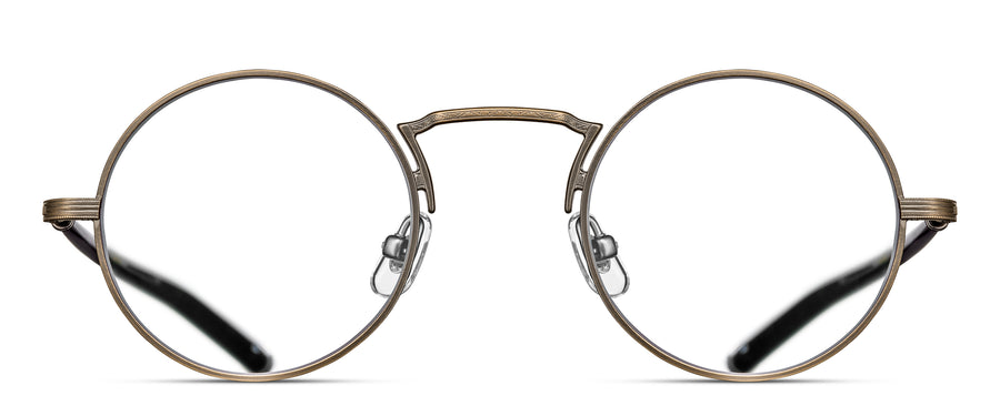 Round eyeglasses in an antique gold frame with a high nose bridge on a white background