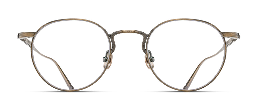 Round eyeglasses with thin antique gold metal frame on a white background